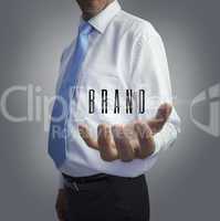 Businessman holding the word brand