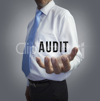 Businessman holding the word audit