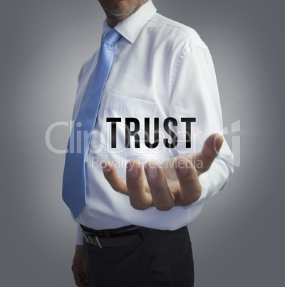 Businessman holding the word trust