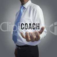 Businessman holding the word coach