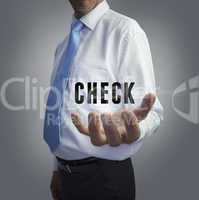 Businessman holding the word check