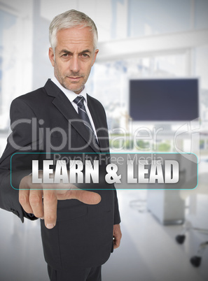Businessman touching the term learn and lead