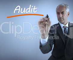 Businessman writing the word audit