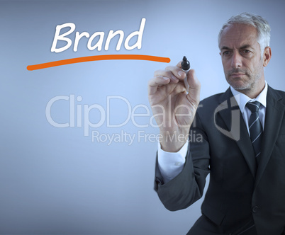 Businessman writing the word brand