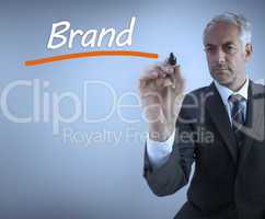 Businessman writing the word brand