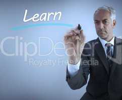 Businessman writing the word learn