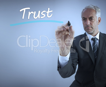 Businessman writing the word trust