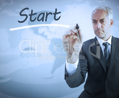 Businessman writing the word start