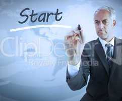 Businessman writing the word start