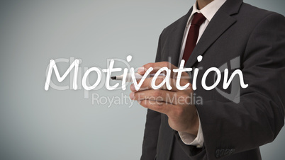 Businessman writing the word motivation