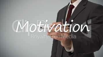 Businessman writing the word motivation