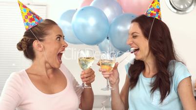 Women clinking their flutes of champagne celebrating a birthday