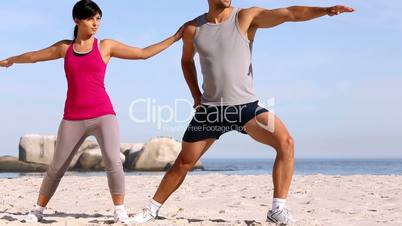 Man and woman training on the beach