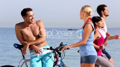 Cheerful friends holding bikes
