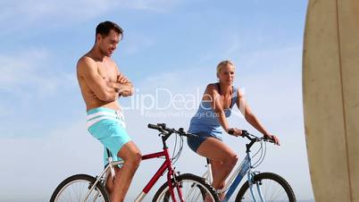 Two friends on bikes speaking