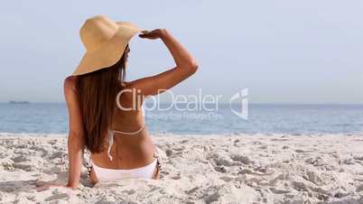 Beautiful brunette with hat tanning