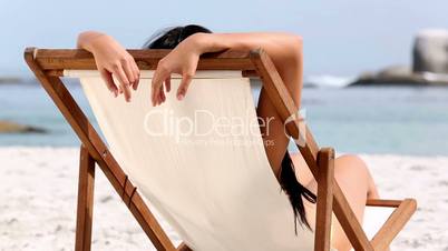 Woman resting on deck chair