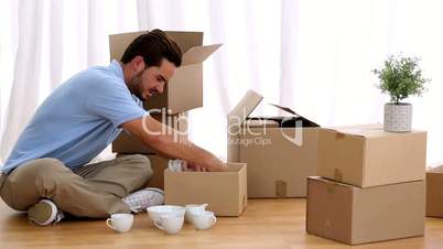Attractive man opening his moving boxes