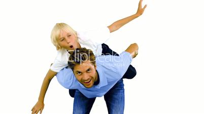 Son having a piggy back on his father on white background