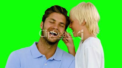 Son pinching the ear of his father on green screen