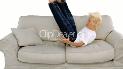 Boy jumping on the sofa on white background