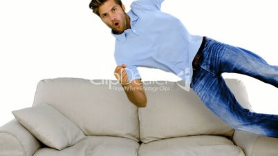 Man jumping on the sofa on white background