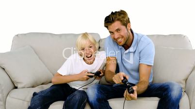 Father and son playing video games on white background