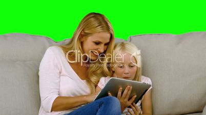Mother and her daughter using digital tablet in slow motion