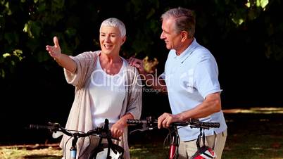 Wife showing something to her husband in a park