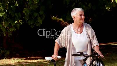 Lost woman walking with her bicycle