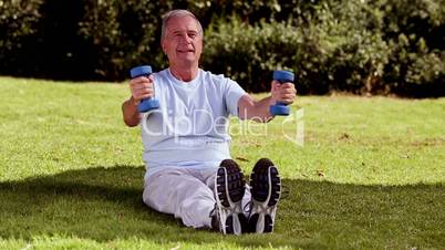 Mature man lifting dumbbells