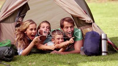 Young family lying in their tent