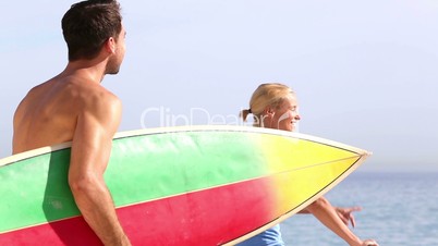 Surfer holding surfboard