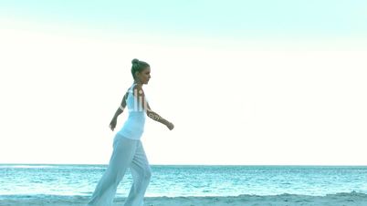 Woman dancing on the beach