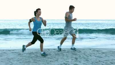 Sporty people running on the beach