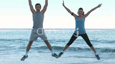 Attractive people working out on the beach