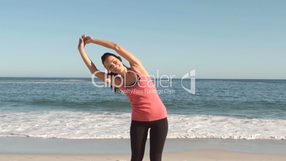 Woman doing exercises on the beach