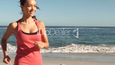 Attractive woman running on the beach