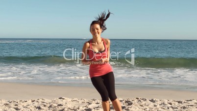 Cheerful woman working out on the beach