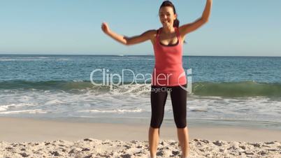 Woman running and jumping on the beach