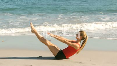 Happy woman working out on beach