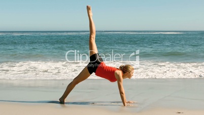 Woman doing exercises at the beach