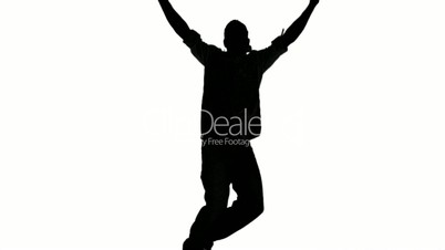 Silhouette of a man jumping and raising arms on white background