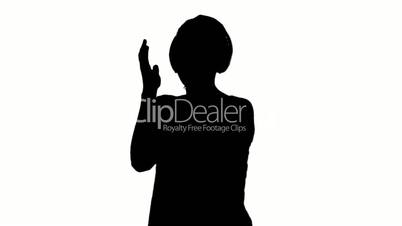 Silhouette of woman listening to music on white background