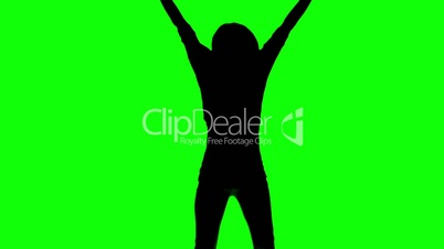 Silhouette of a woman jumping and raising her arms on green screen