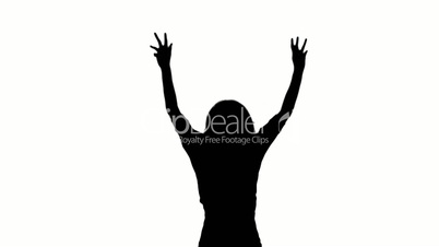 Silhouette of a woman jumping and raising her arms on white background
