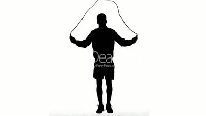 Silhouette of a man working out with a rope on white background