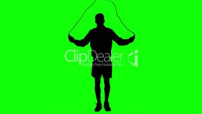 Silhouette of a man working out with a rope on green screen