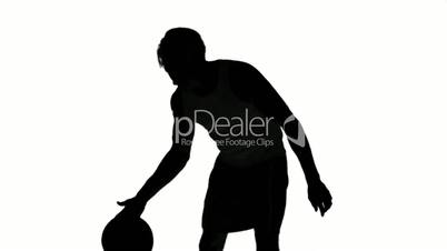 Silhouette of a man playing basket on white background