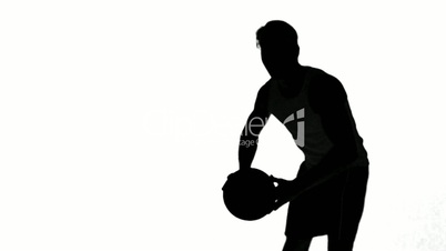 Silhouette of a man throwing a basketball on white background